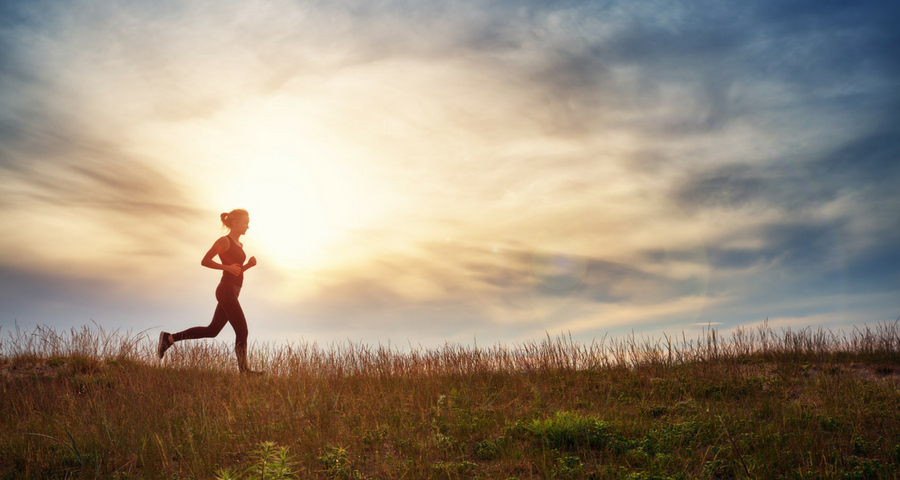 a woman goes for a run through a meadow