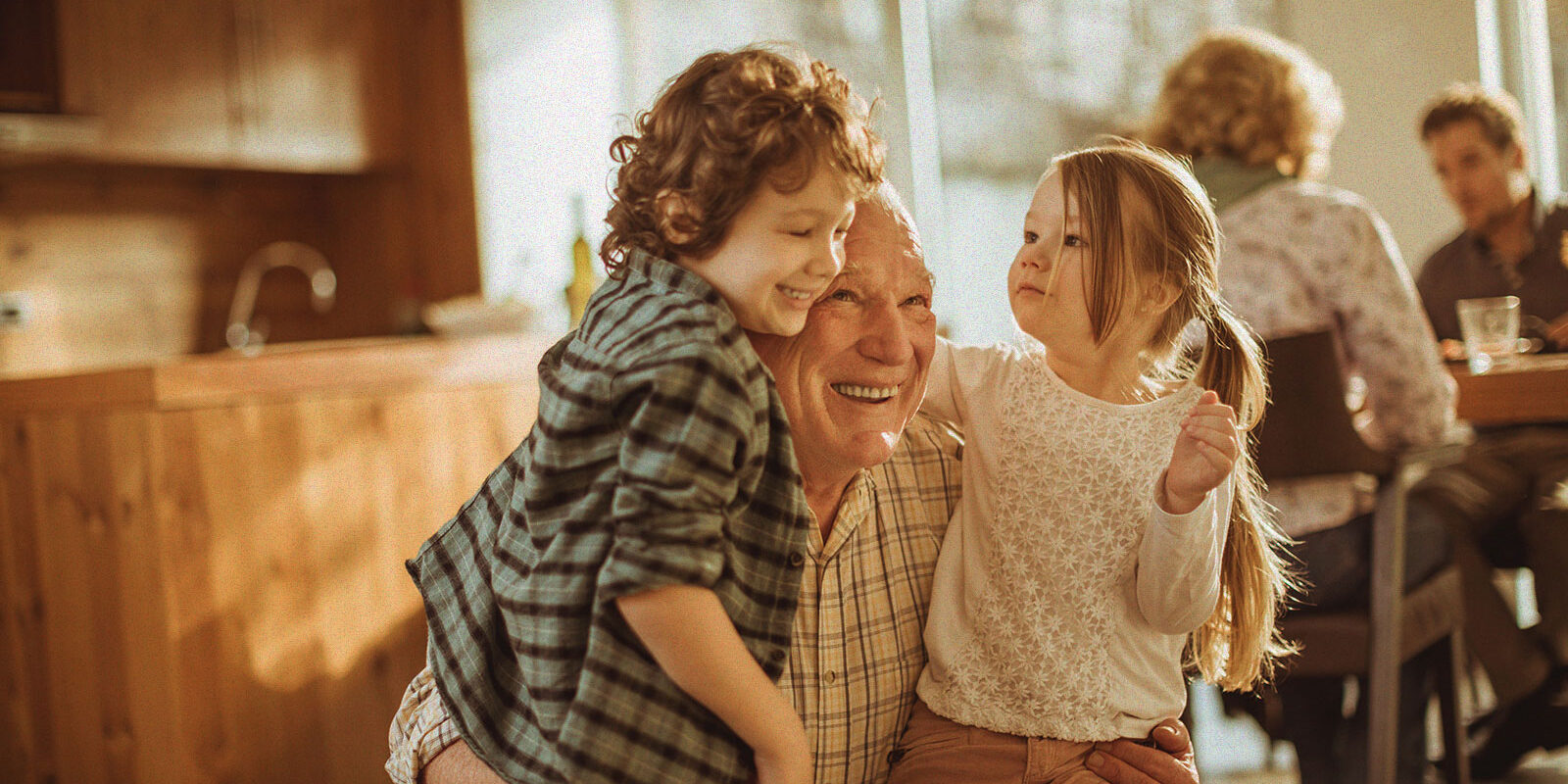 a grandfather holding his grandchildren