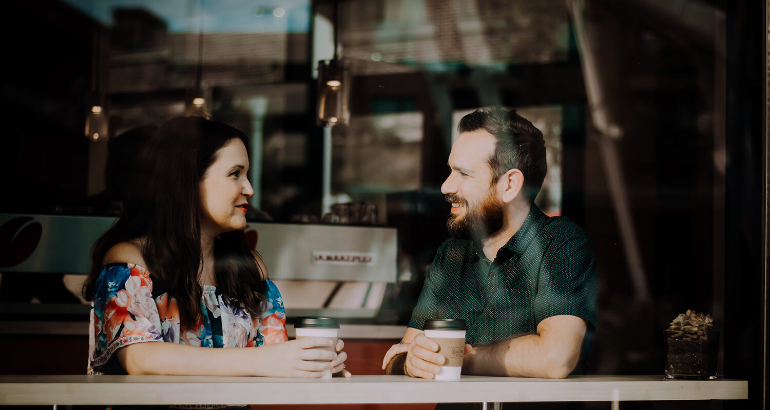 a nonprofit leader engages in conversation with a major donor at a coffee shop