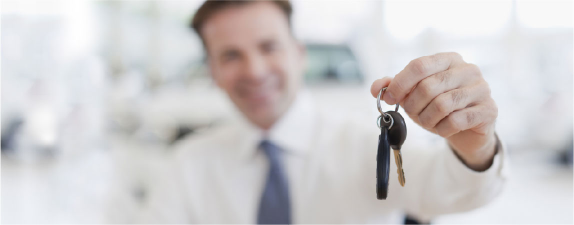 a car dealer handing you the keys