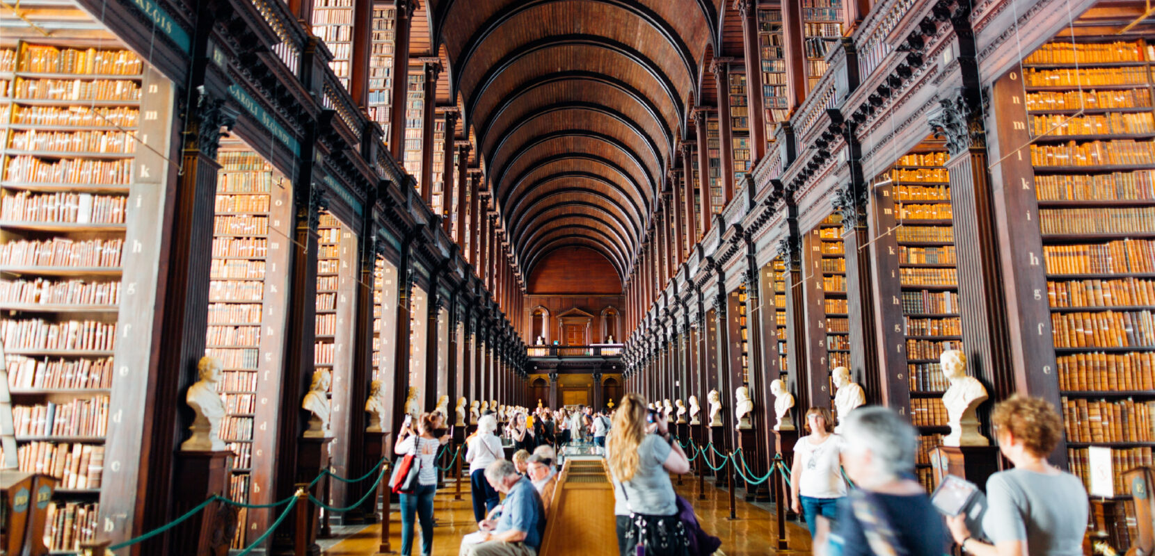 a large library filled with books and people