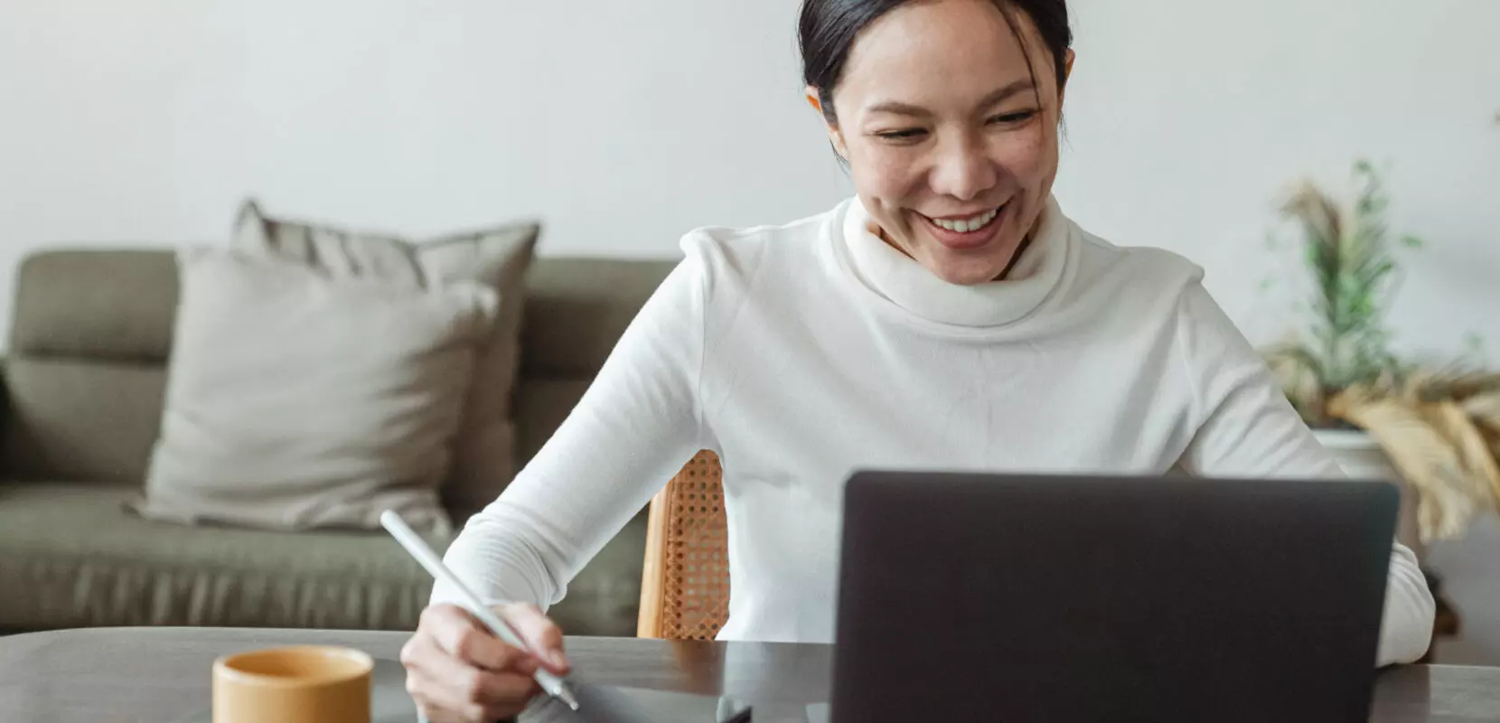 a woman sitting at her desk working on her computer
