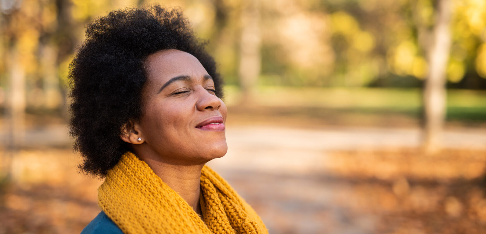 woman outside enjoying the fall weather