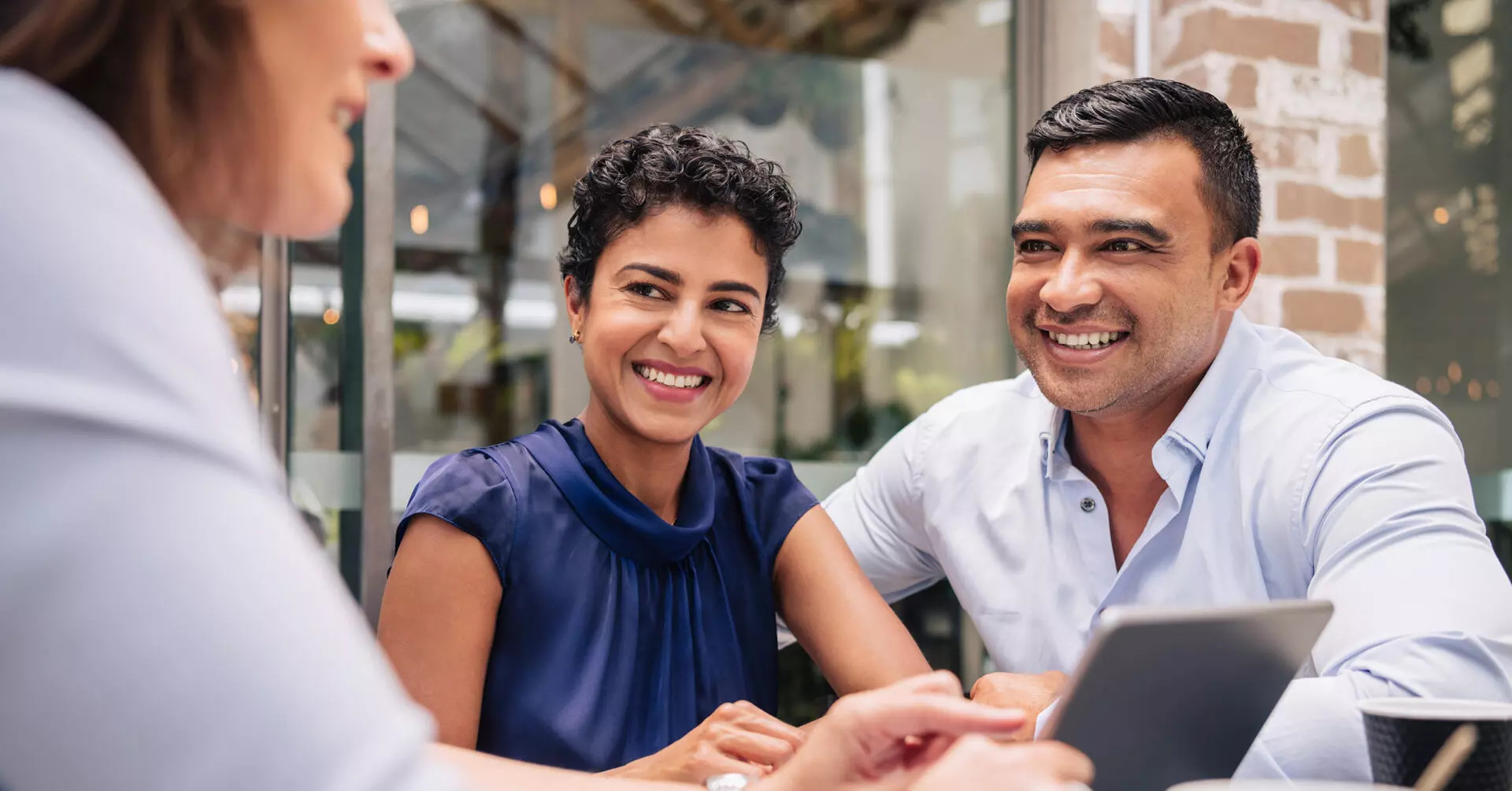 smiling couple meeting with a financial advisor