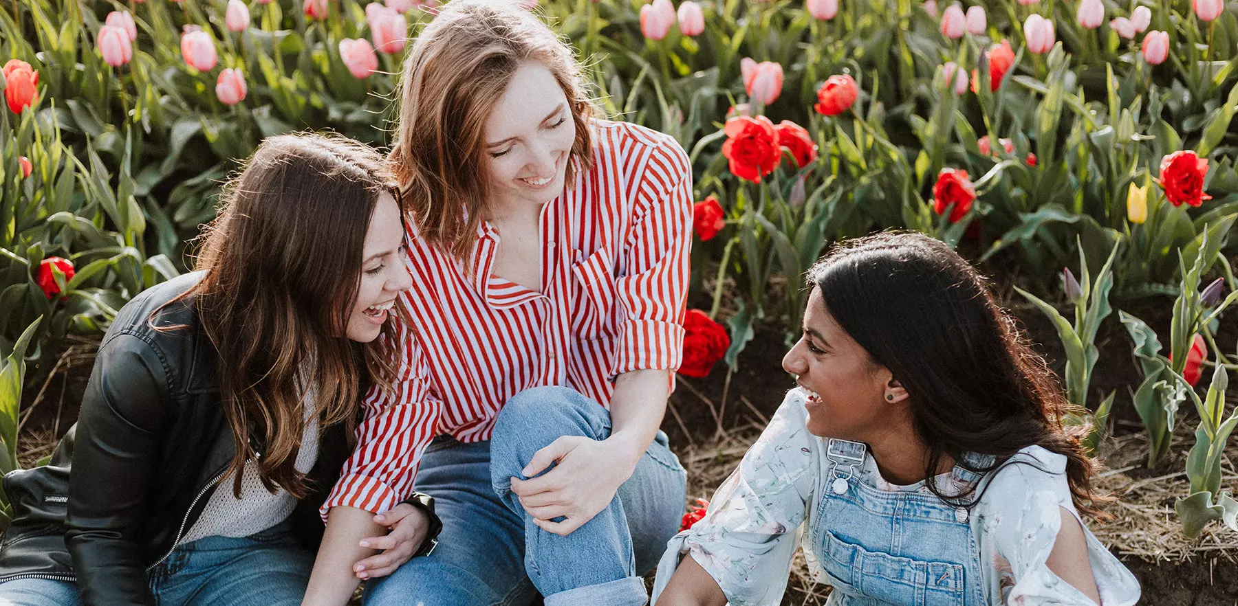 a group of friends sit by a flowery meadow and discuss starting a giving circle