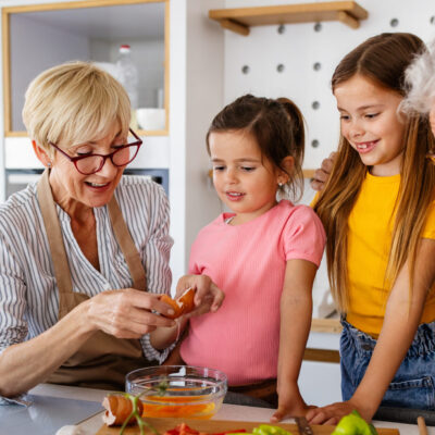 grandparents and grandchildren working on acts of generosity by baking together