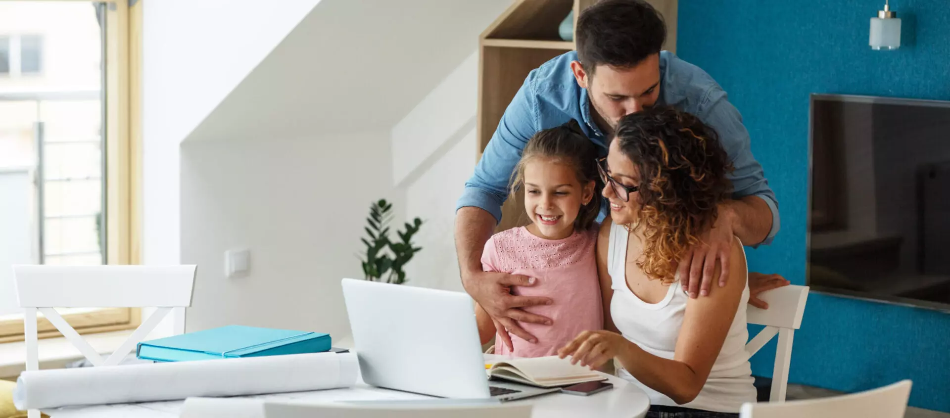 Happy family in living room hugging as they align their values and their giving