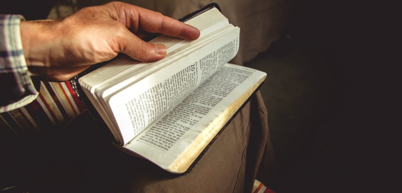 a man flips through his bible