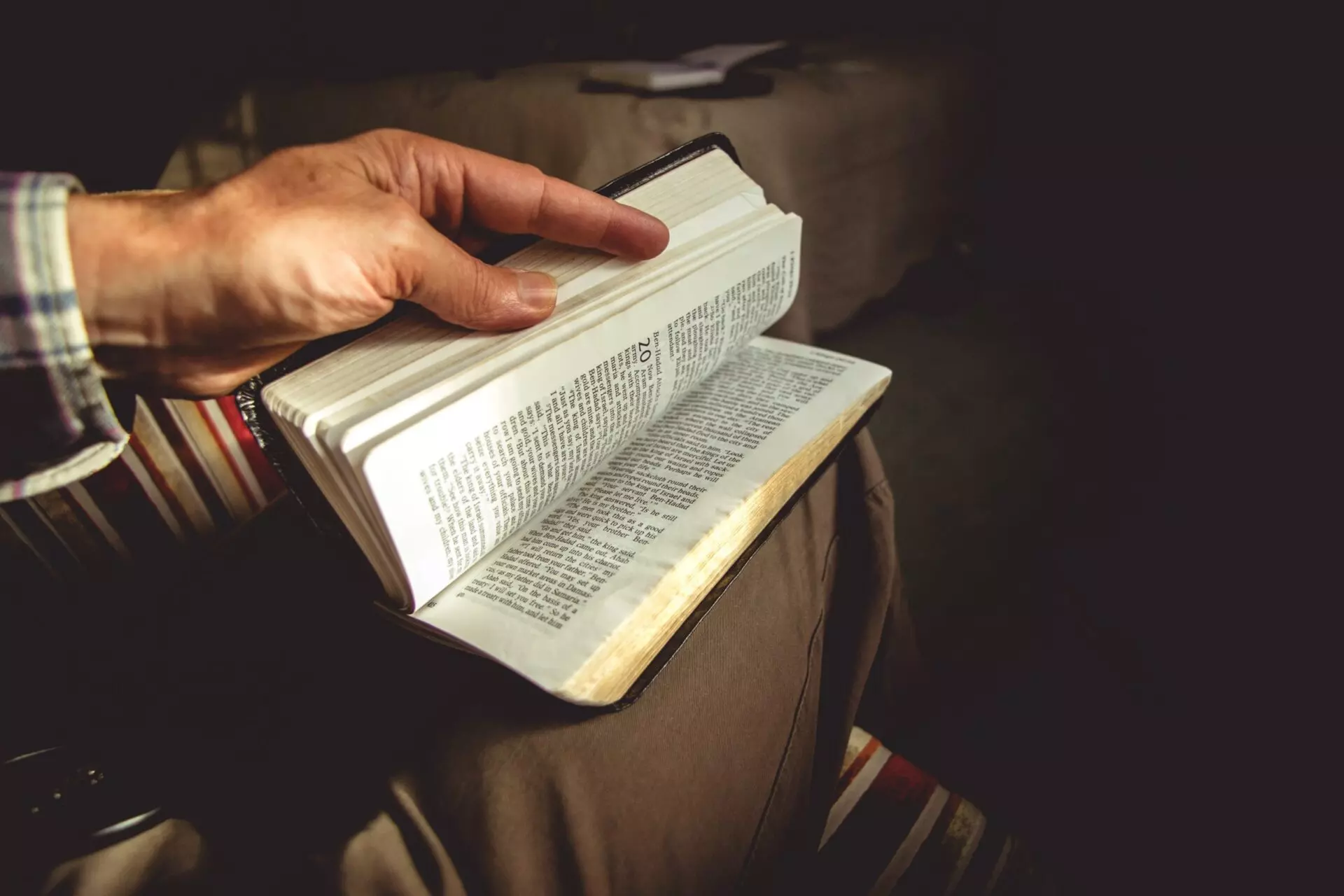 a man flips through his bible