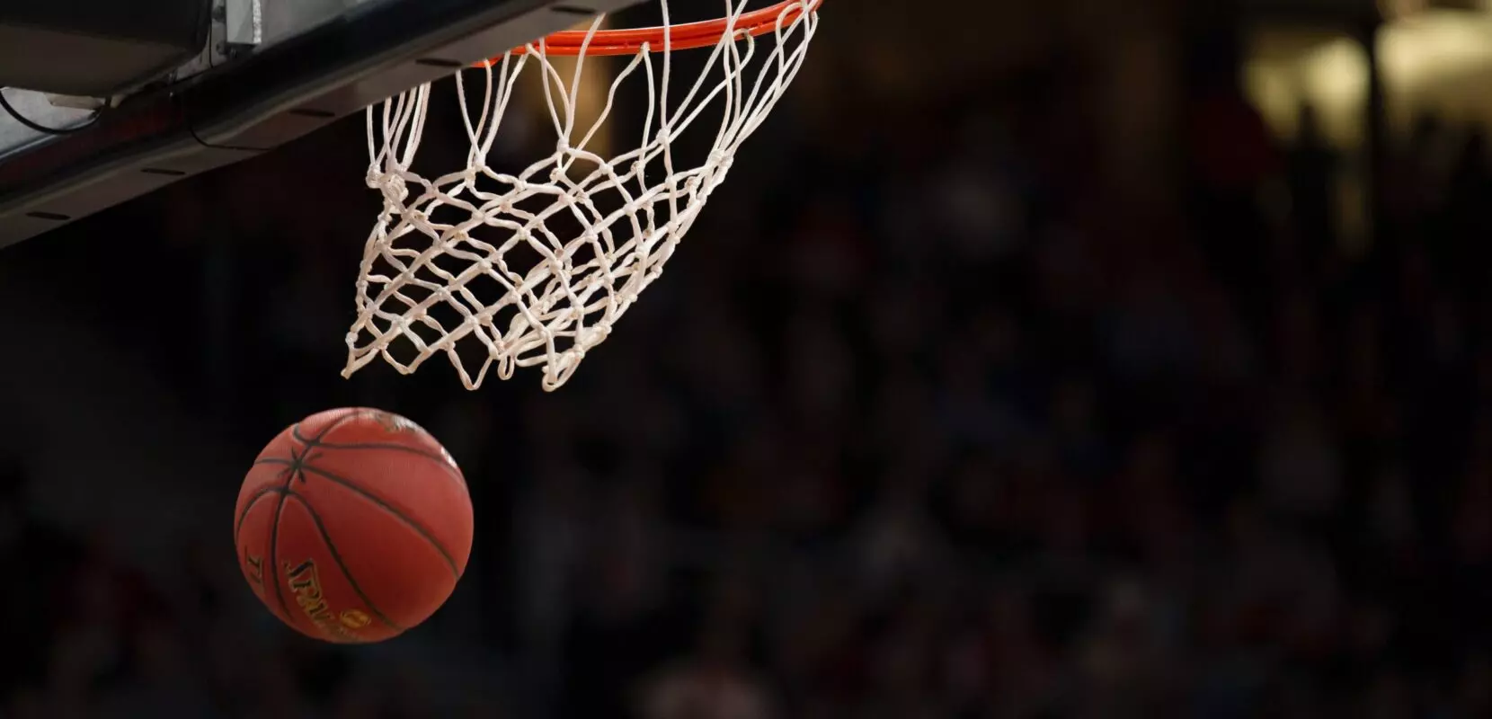a basketball has just gone through the hoop