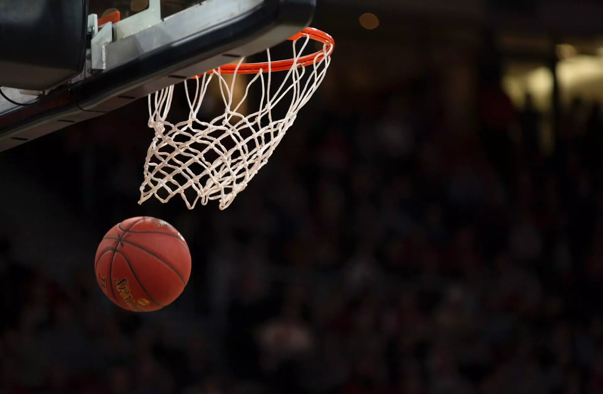 a basketball has just gone through the hoop