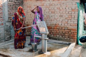 Two women rejoice that clean water is now in their village in India.