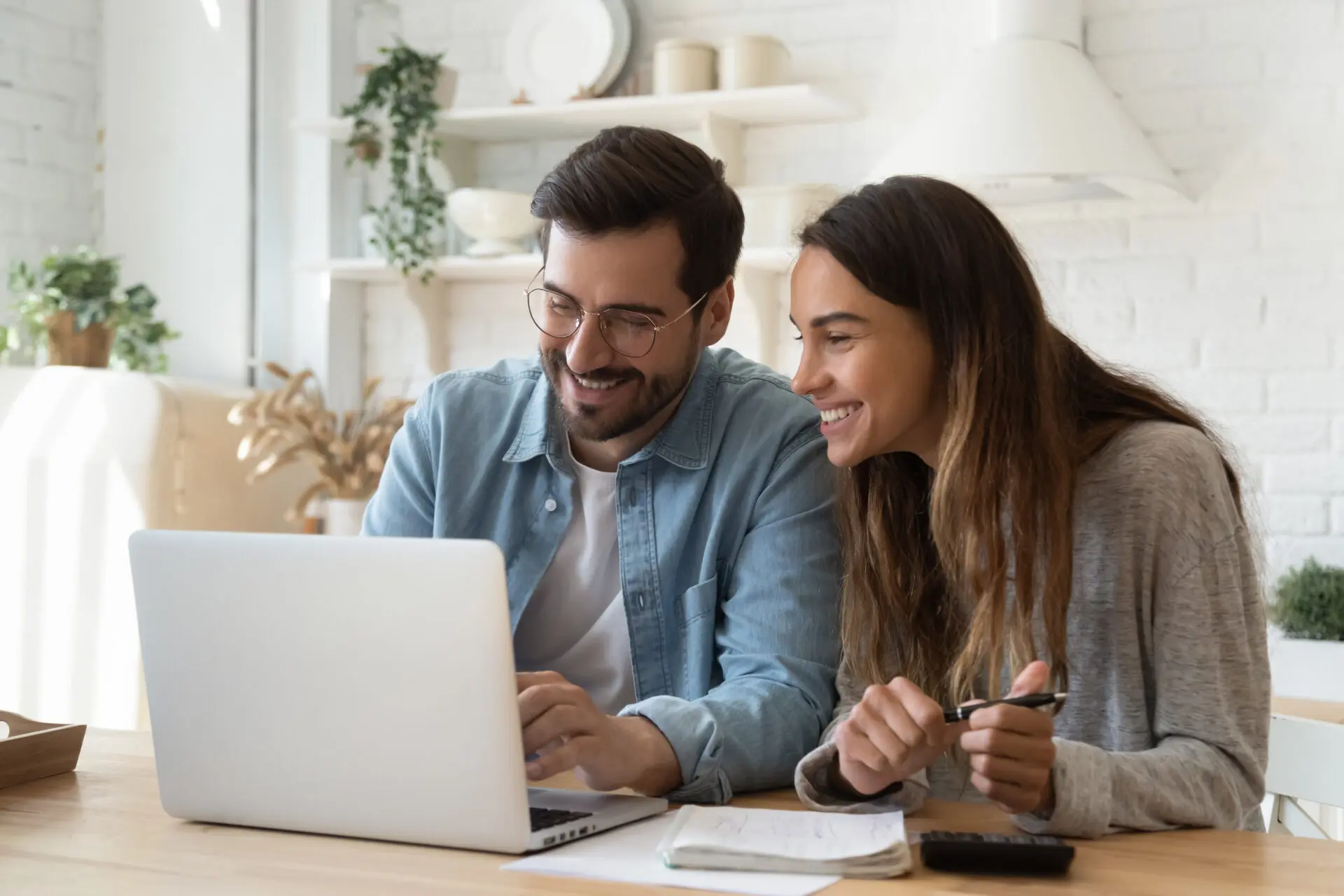 couple happily looking at computer
